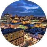 Nighttime city scene of Kitchener, Canada, with a dramatic sky and lots of buildings.