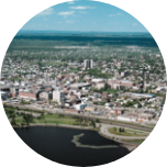 Built up city scene of Thunder Bay, Canada, with lots of buildings expanding backwards from the waters edge.