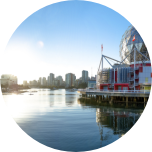 A river in the forefront of the image, surrounded by a cityscape skyrise buildings.