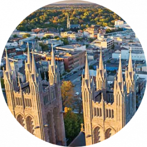 Twin cathedral tops with city buildings in the background in Guelph, Canada.