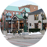 A lamppost clock and surrounding buildings in the town centre of Oakville, Canada.