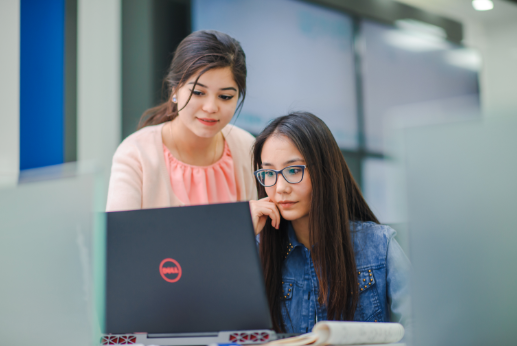 two women preparing for ielts on computer