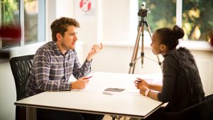 Two people talking at the IELTS exam