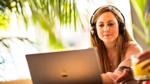 A woman practicing her listening skills in her computer