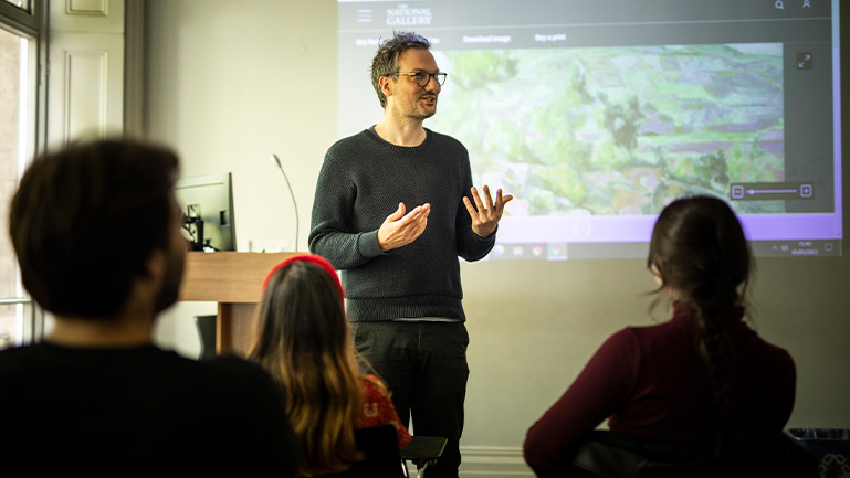 A teacher gives a class considering English for everyone.