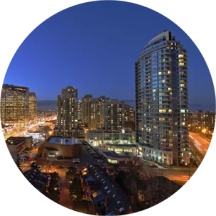 City buildings in North York, Canada, at nighttime, with city lights dotted throughout.