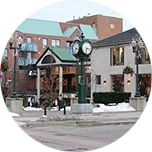 A lamppost clock and surrounding buildings in the town centre of Oakville, Canada.